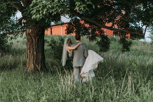pottery husband carrying his wife walking beside trees vase